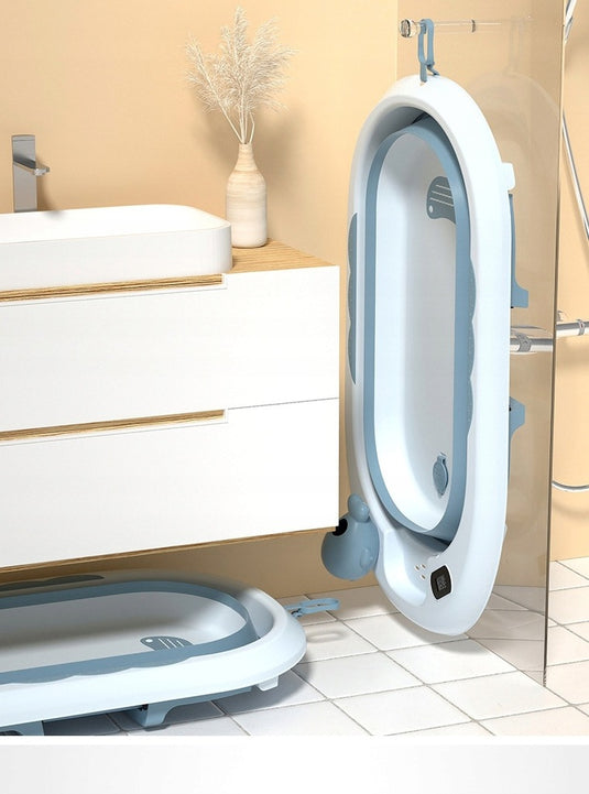 Cadita bebelusi pliabila cu pernuta UniqViBE®, termometru incorporat, cana pentru clatire tip jucarie, suport cap de dus si pentru sapun, cu perna din material hipoalergenic, lavabil cu uscare rapida, picioare antiderapante, design Ergonomic, Blue Royal