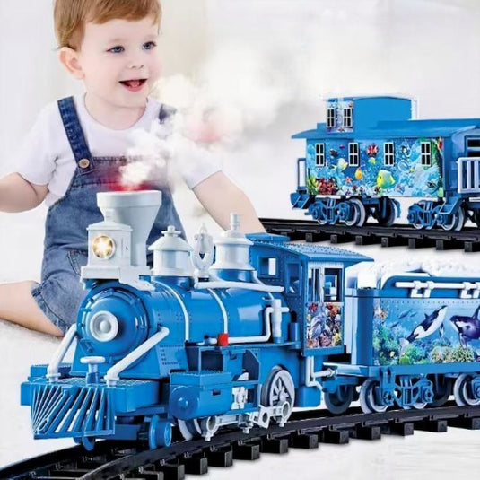 Trenulet Electric cu Aburi OceanExpress pentru Copii, Include Tren Electric cu Efecte Sonore, Lumini, Fum Real, 3 Vagoane, 16 Sine, Model Animalute Marine, Indiggo@, Blue Ocean, +3 Ani